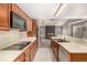 Modern kitchen featuring stainless appliances, a breakfast bar, and natural light, perfect for cooking at 7501 S Ivanhoe Cir, Centennial, CO 80112