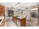 Open kitchen with a serving counter, stainless appliances, and a view to the Gathering room at 7501 S Ivanhoe Cir, Centennial, CO 80112
