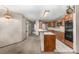 Open kitchen with an island, stainless steel appliances, and wood cabinets for a functional space at 7501 S Ivanhoe Cir, Centennial, CO 80112