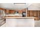 Well-lit kitchen featuring an island, wooden cabinets, and modern appliances for a functional cooking space at 7501 S Ivanhoe Cir, Centennial, CO 80112
