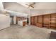 Spacious living area with an open layout, kitchen access, vaulted ceilings, and built-in bookshelves at 7501 S Ivanhoe Cir, Centennial, CO 80112