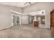 Open-concept living area featuring sliding glass doors and an eat-in kitchen with stainless steel appliances at 7501 S Ivanhoe Cir, Centennial, CO 80112