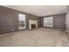 A large living room has large windows and a fireplace at 7501 S Ivanhoe Cir, Centennial, CO 80112