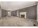 A bright and open living room features a classic fireplace and neutral carpeting at 7501 S Ivanhoe Cir, Centennial, CO 80112