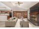 Bright living room with a cozy fireplace, built-in bookshelves, and an open layout to the kitchen at 7501 S Ivanhoe Cir, Centennial, CO 80112