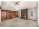 Large living room featuring an expansive built-in bookshelf and brick fireplace, offering ample natural light at 7501 S Ivanhoe Cir, Centennial, CO 80112