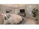 Serene main bedroom with a ceiling fan and a view into the ensuite bathroom, creating a private retreat at 7501 S Ivanhoe Cir, Centennial, CO 80112