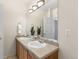 Bathroom showcasing a dual vanity with stone countertops and a well-lit mirror at 9307 Amison Cir # 202, Parker, CO 80134