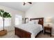 Cozy bedroom with a wooden bed frame, neutral tones, and natural light streaming through the windows at 9307 Amison Cir # 202, Parker, CO 80134