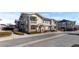 Exterior shot of a condo with a small yard, balcony, and stone columns at 9307 Amison Cir # 202, Parker, CO 80134