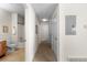 Hallway leading to bathroom with light carpet and white doors at 9307 Amison Cir # 202, Parker, CO 80134