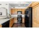 Bright kitchen showcasing wood cabinets, granite countertops, and modern black appliances at 9307 Amison Cir # 202, Parker, CO 80134