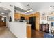 Open kitchen with light wood cabinetry, black appliances, and granite countertops flowing into the dining area at 9307 Amison Cir # 202, Parker, CO 80134