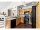 A well-lit kitchen featuring wood cabinets and black appliances, creating a blend of classic and modern style at 9307 Amison Cir # 202, Parker, CO 80134