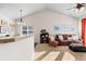Spacious living room featuring vaulted ceiling, neutral tones, an open design, and lots of natural light at 9307 Amison Cir # 202, Parker, CO 80134