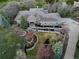 Expansive aerial view showcasing the home's landscaped grounds, outdoor fire pit, and elegant circular driveway at 5631 Silver Bluff Ct, Parker, CO 80134