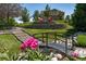 Beautiful backyard with stone terracing, a charming bridge, and a fire pit, perfect for outdoor enjoyment at 5631 Silver Bluff Ct, Parker, CO 80134