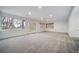 Finished basement with large windows, french doors, and neutral carpeting at 5631 Silver Bluff Ct, Parker, CO 80134
