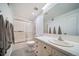 Clean bathroom featuring a tub, toilet, and vanity with tile countertops, as well as a tiled shower with glass doors at 5631 Silver Bluff Ct, Parker, CO 80134