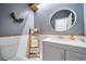 Chic half-bathroom features stylish fixtures, decor, and a modern vanity at 5631 Silver Bluff Ct, Parker, CO 80134