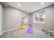 Exercise room with natural light, large mirror, and neutral carpeting at 5631 Silver Bluff Ct, Parker, CO 80134