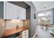 Kitchen nook featuring white cabinets, wood counters, subway tile backsplash and wine storage at 5631 Silver Bluff Ct, Parker, CO 80134
