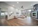 Open living room boasts high ceilings, large windows, and a cozy fireplace at 5631 Silver Bluff Ct, Parker, CO 80134