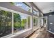 Open Living room with views of mature trees, floor to ceiling windows, and doors to back deck at 5631 Silver Bluff Ct, Parker, CO 80134