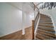 Beautiful staircase featuring decorative tiling on the risers, complemented by a wooden railing and white accents at 5631 Silver Bluff Ct, Parker, CO 80134