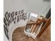 Elegant curved staircase with wooden steps, a dark railing, and decorative Gathering photographs on the wall at 5631 Silver Bluff Ct, Parker, CO 80134