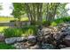 Beautiful water feature with natural stone and landscaping in the backyard at 5631 Silver Bluff Ct, Parker, CO 80134
