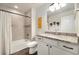 Well-lit bathroom with granite vanity, shower-tub combo, and modern fixtures at 410 Clover Ct, Frederick, CO 80530