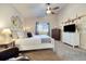 Bright bedroom featuring a ceiling fan, neutral walls, stylish decor, and a cozy carpet at 410 Clover Ct, Frederick, CO 80530