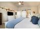Spacious primary bedroom suite featuring barn door to bathroom, dresser and airplane artwork at 410 Clover Ct, Frederick, CO 80530