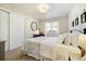 Cozy bedroom with neutral tones, white trim, modern light fixture, and large window at 410 Clover Ct, Frederick, CO 80530