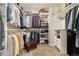 Walk-in closet with custom shelving and hanging racks for optimal storage at 410 Clover Ct, Frederick, CO 80530
