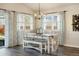 Cozy dining room with seating for six, with open windows and patio door to the back yard at 410 Clover Ct, Frederick, CO 80530