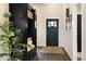 Welcoming entryway with a dark door, decorative wreath, and convenient built-in storage at 410 Clover Ct, Frederick, CO 80530