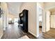 Spacious hallway with hardwood floors, mudroom bench, and views into the living areas at 410 Clover Ct, Frederick, CO 80530