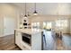 Open kitchen features a large island, stainless steel appliances, and flows into the dining and living areas at 410 Clover Ct, Frederick, CO 80530