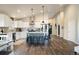 Open-concept kitchen boasting white cabinets, stainless appliances, and a center island with seating at 410 Clover Ct, Frederick, CO 80530