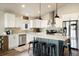 Stylish kitchen featuring quartz countertops, stainless steel appliances, and island seating at 410 Clover Ct, Frederick, CO 80530