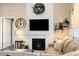 Cozy living room with fireplace, decorative mantel, large TV, and comfortable seating at 410 Clover Ct, Frederick, CO 80530