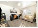 Comfortable home office featuring shiplap accent wall, neutral sofa, and ample natural light at 410 Clover Ct, Frederick, CO 80530