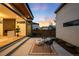 Stylish backyard featuring a concrete patio, modern fire pit, and privacy fence, ideal for relaxation and social gatherings at 2926 S Cherokee St, Englewood, CO 80110