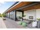 Covered outdoor patio with fireplace, comfortable seating, and contemporary design details at 2926 S Cherokee St, Englewood, CO 80110
