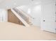 Finished basement features modern stairs with wood accents and clean, bright, white walls at 2926 S Cherokee St, Englewood, CO 80110