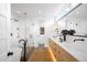 Modern bathroom with dual sinks, sleek countertops, and luxurious shower and tub at 2926 S Cherokee St, Englewood, CO 80110