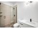 This modern bathroom features a glass shower, tile and white vanity at 2926 S Cherokee St, Englewood, CO 80110