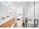 Bright, modern bathroom showcasing a double sink vanity and a glimpse into the bedroom at 2926 S Cherokee St, Englewood, CO 80110